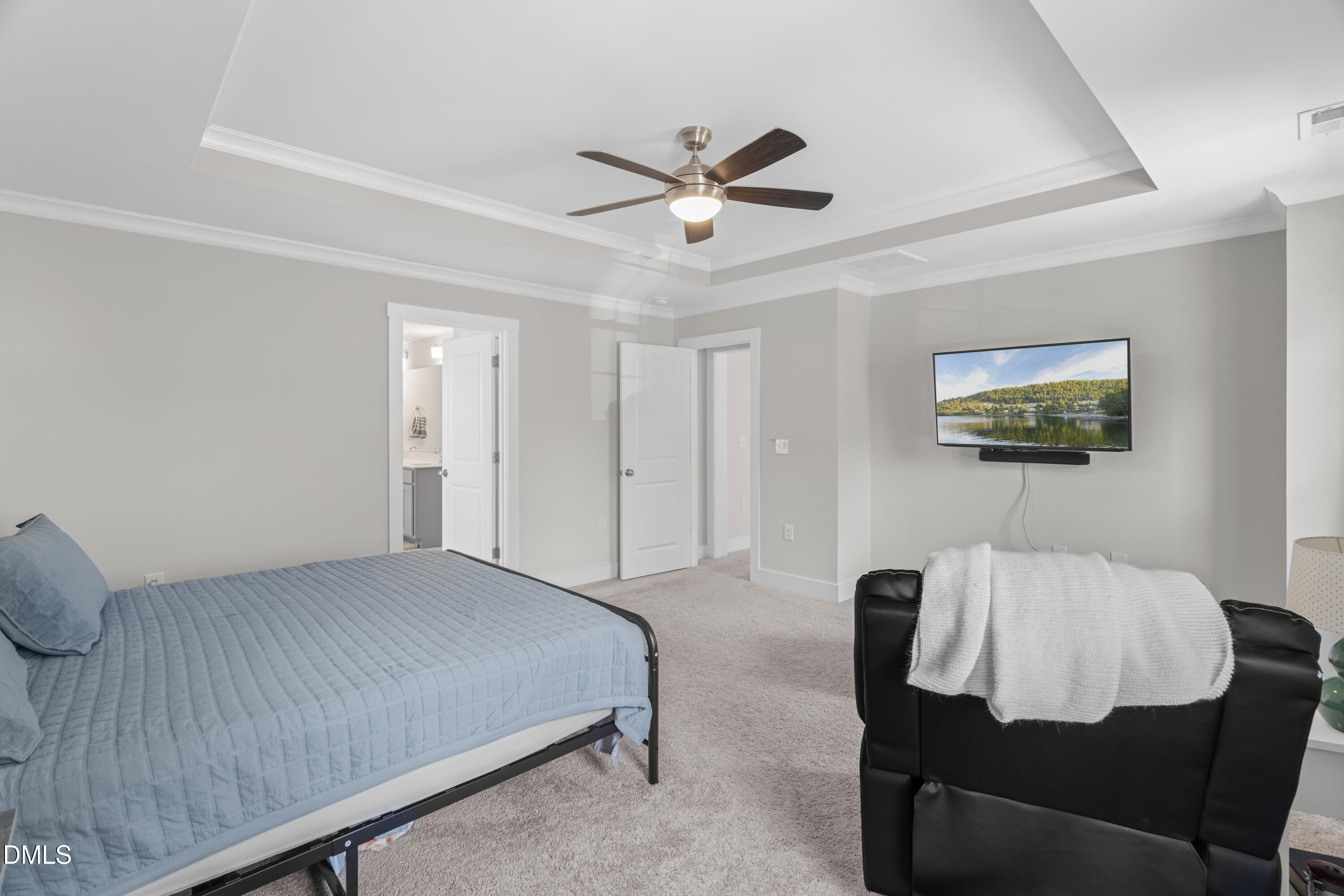 108 Bridge Street Smithfield, NC 27577 - Photo 20 of 48 a bedroom with a bed and a chandelier