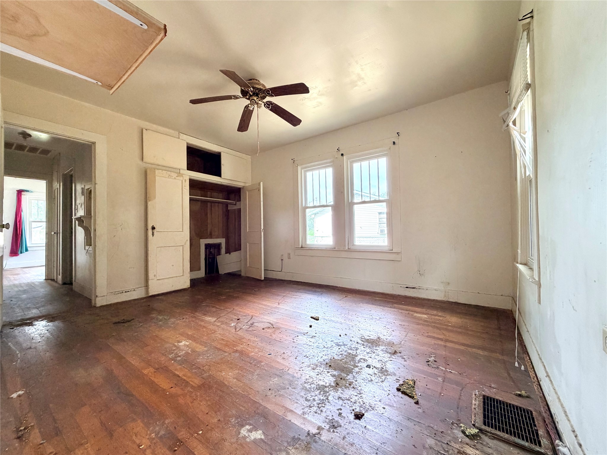702 East 18th Street Cameron, TX 76520 - Photo 11 of 14 This bedroom offers hard wood flooring and abundant light from multiple windows.