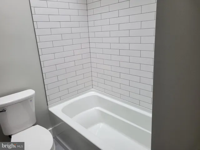 a bathroom with a bathtub and toilet