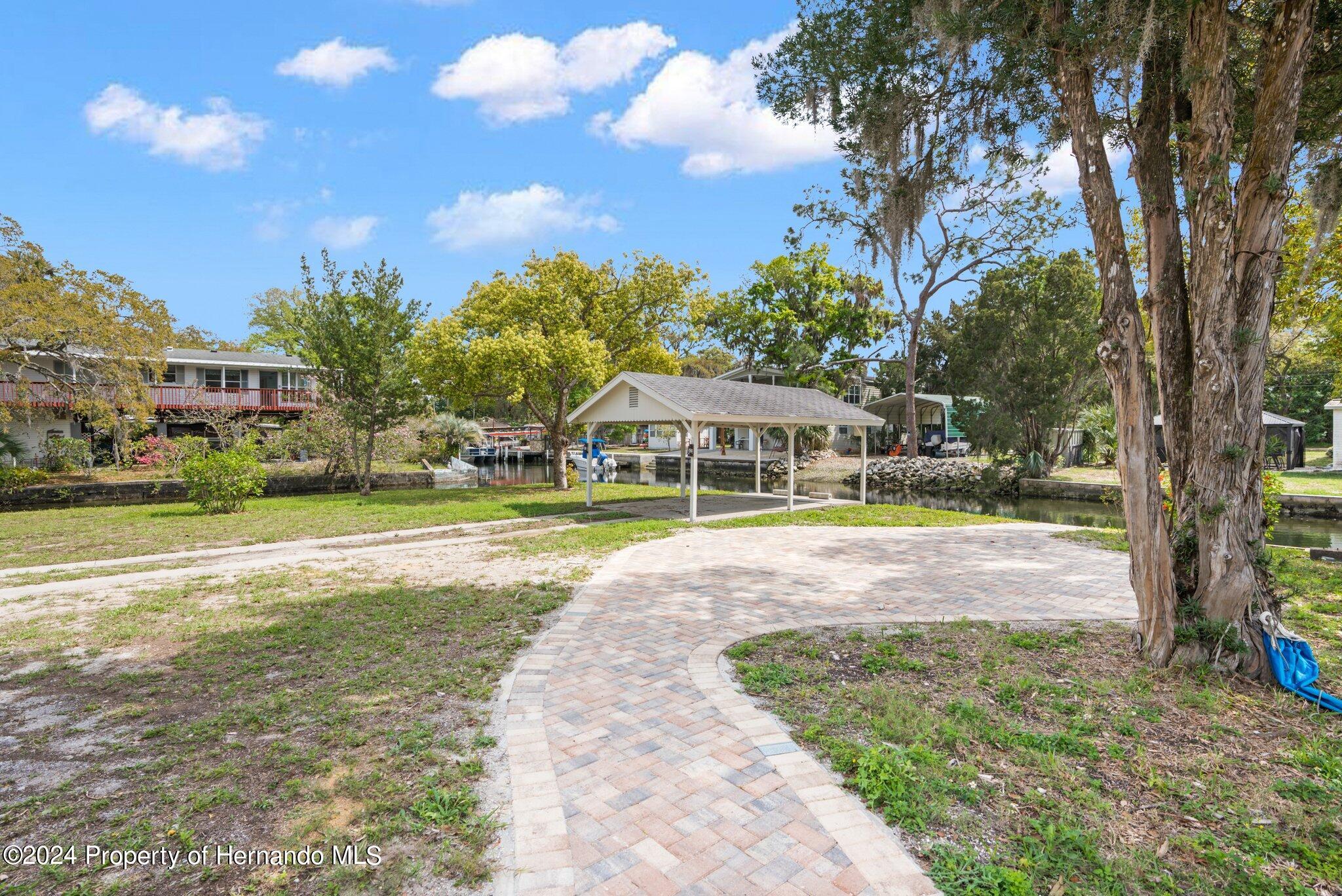 5411 Teal Drive Weeki Wachee, FL 34607 - Photo 23 of 40 a view of yard with swimming pool and outdoor seating
