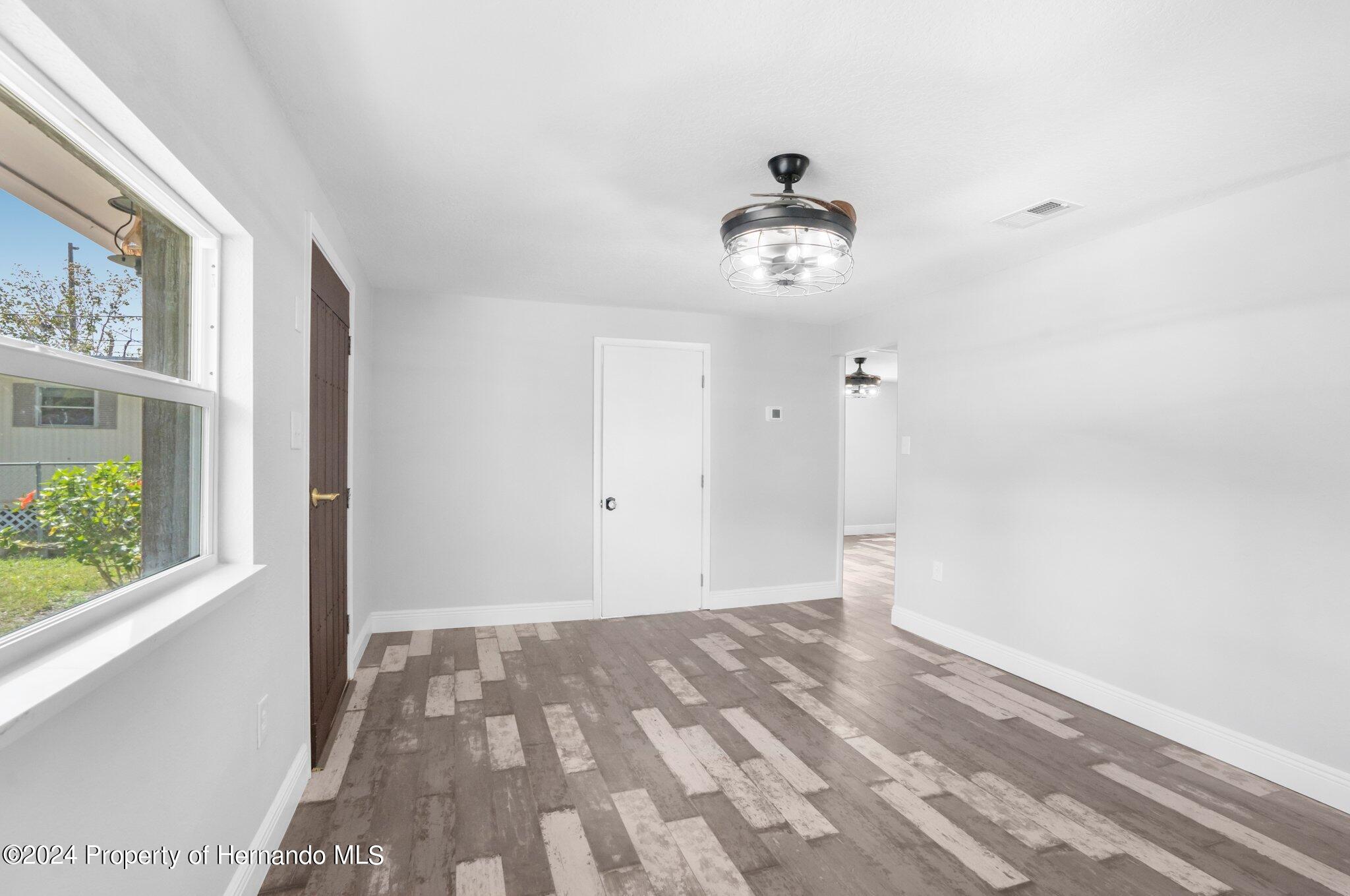 5411 Teal Drive Weeki Wachee, FL 34607 - Photo 27 of 40 a view of room with a ceiling fan and window