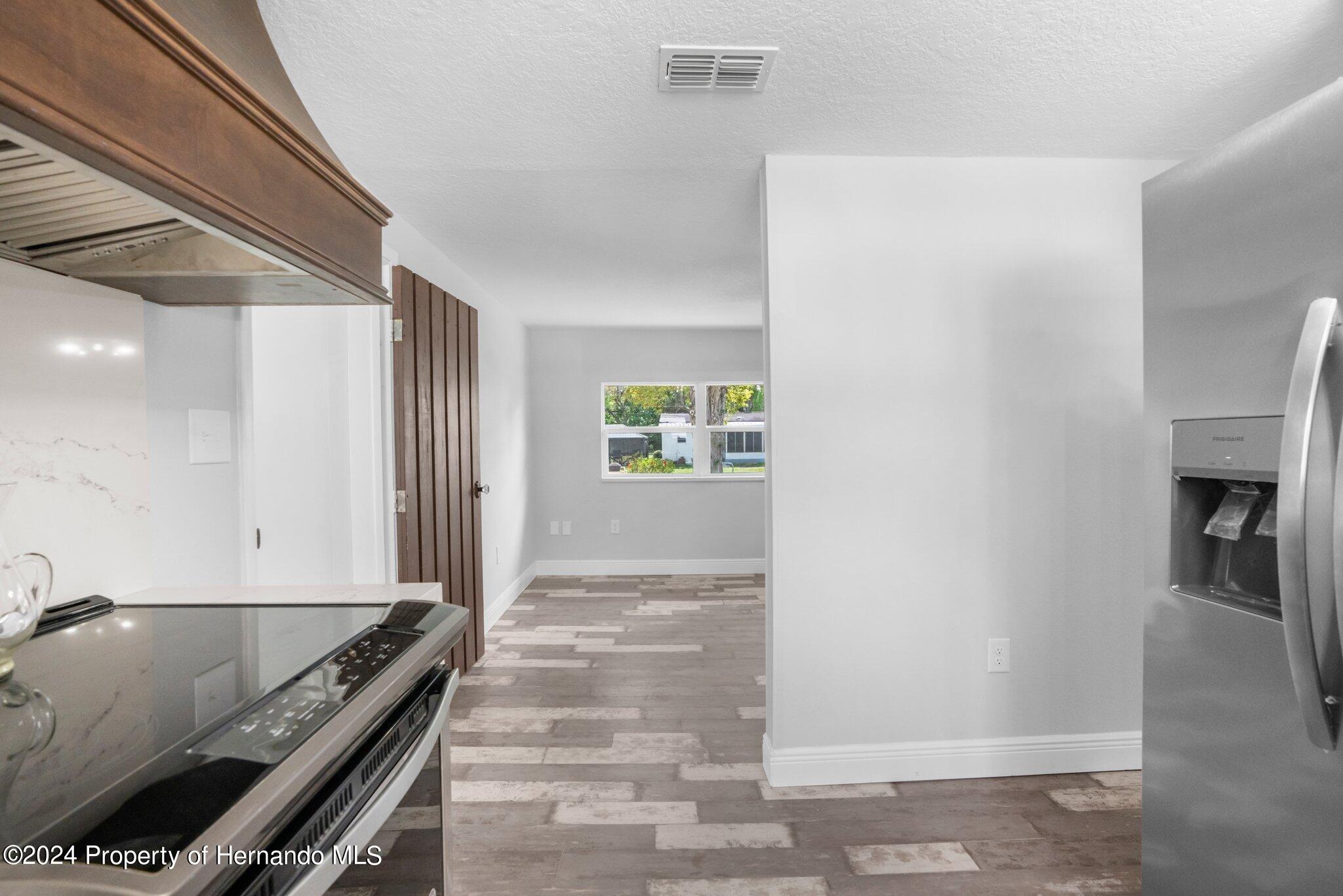 5411 Teal Drive Weeki Wachee, FL 34607 - Photo 28 of 40 a view of an entryway with wooden floor