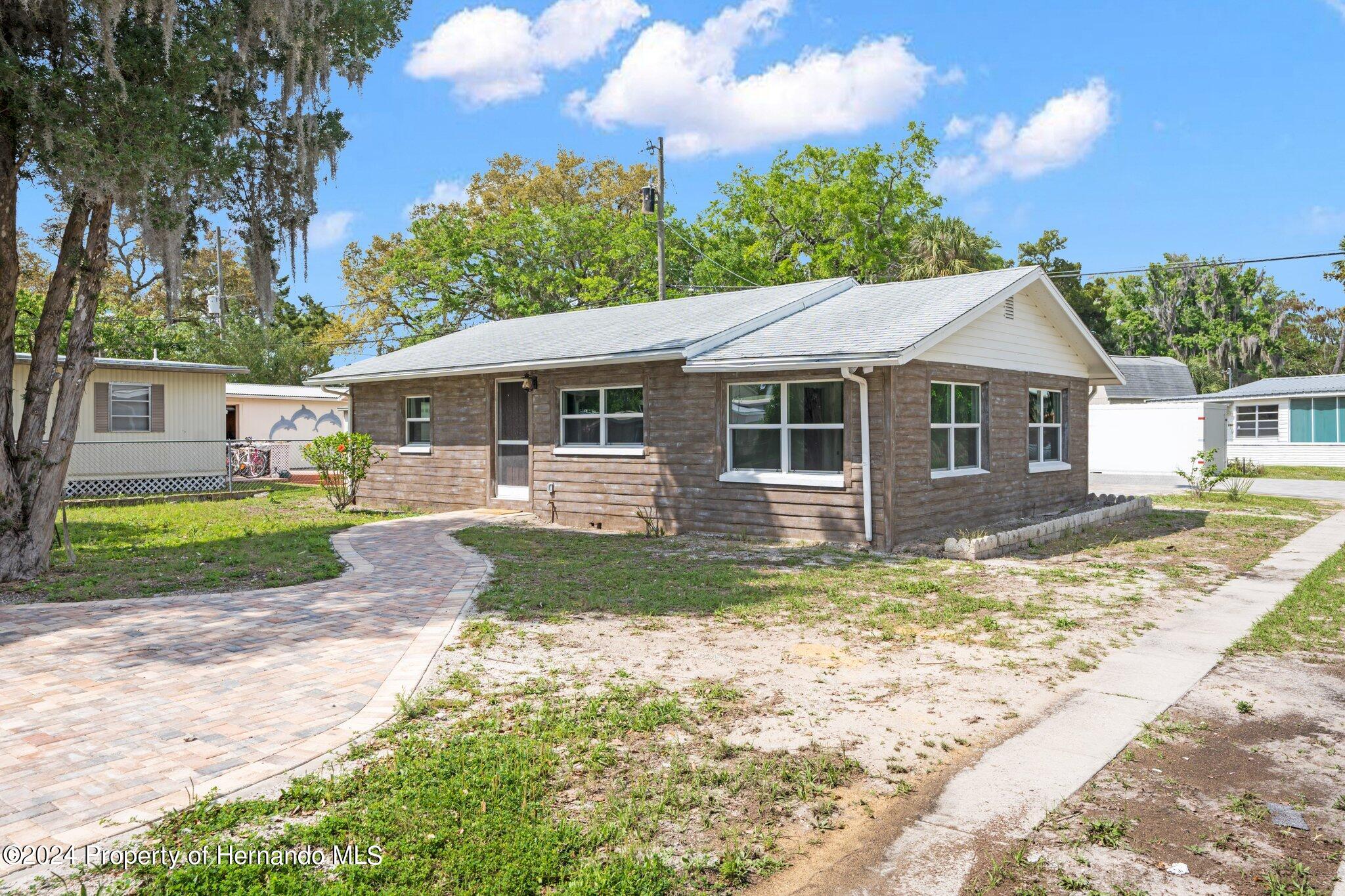 5411 Teal Drive Weeki Wachee, FL 34607 - Photo 3 of 40 a view of a yard in front of the house