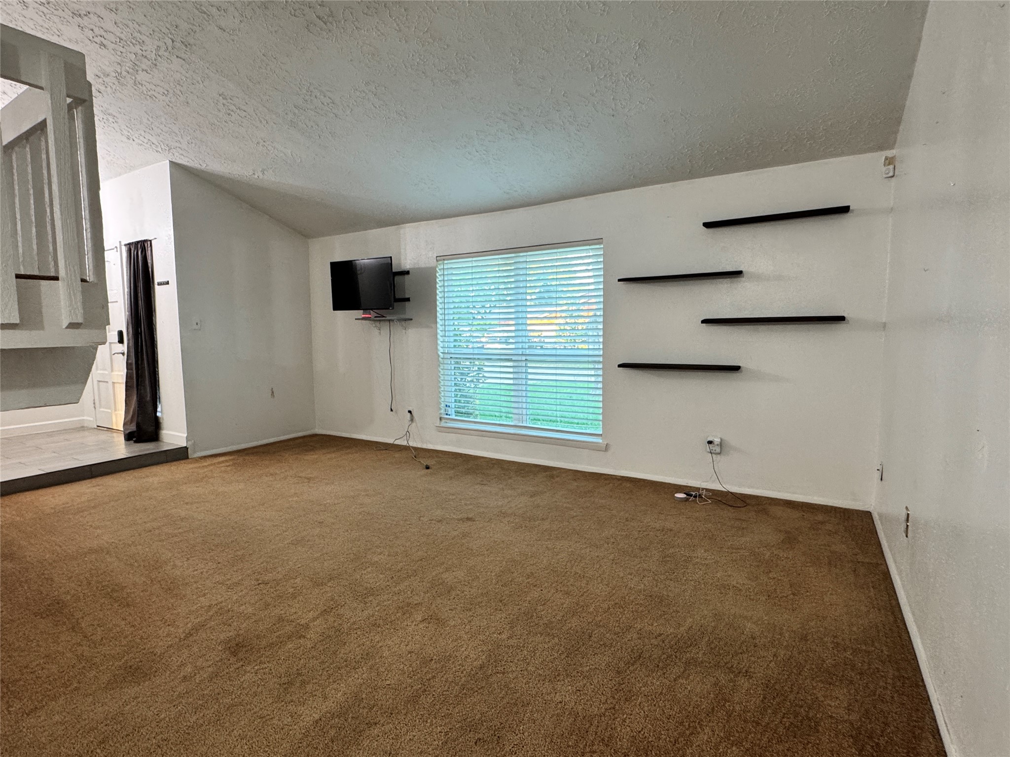 8519 Church Light Lane Houston, TX 77064 - Photo 12 of 24 an empty room with a empty space and windows
