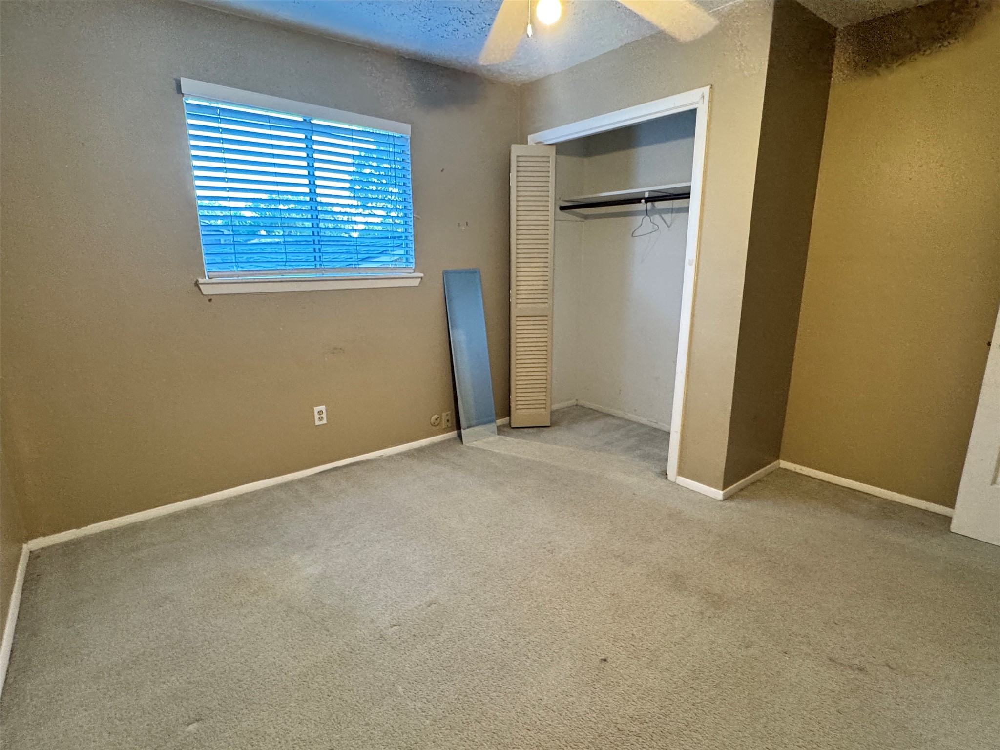8519 Church Light Lane Houston, TX 77064 - Photo 19 of 24 an empty room with windows and closet
