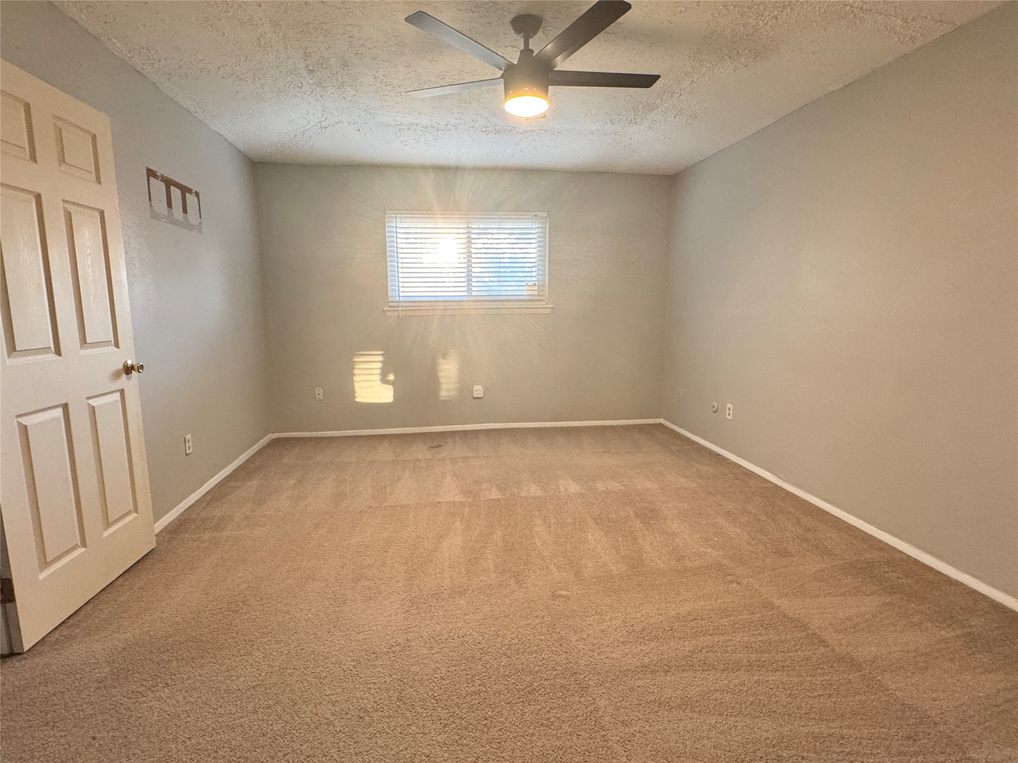 8519 Church Light Lane Houston, TX 77064 - Photo 21 of 24 an empty room with a window and a fan