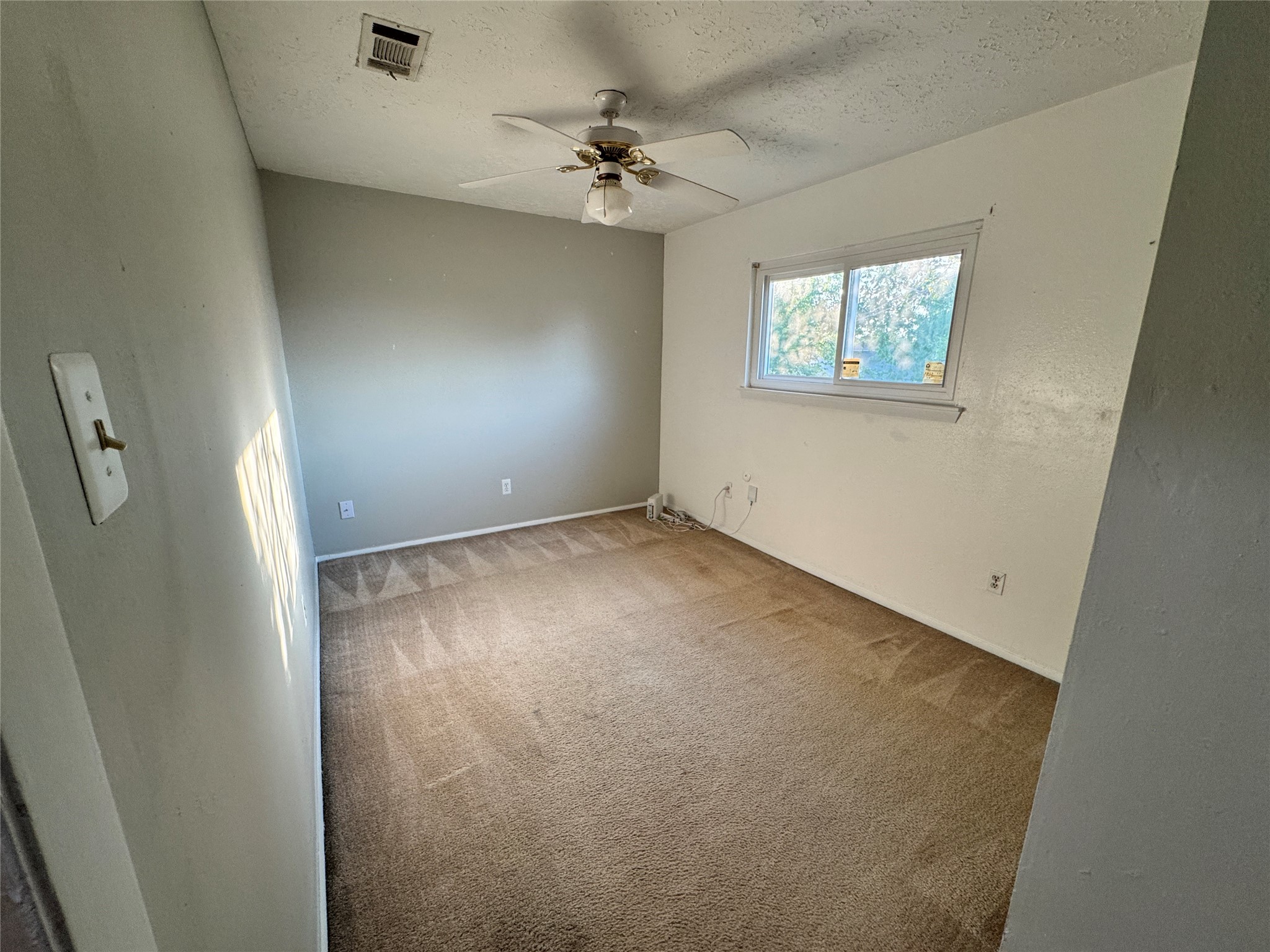 8519 Church Light Lane Houston, TX 77064 - Photo 8 of 24 an empty room with windows and fan