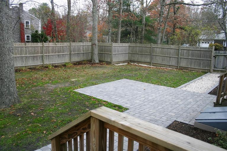 6 Fox Hill Road Centerville, MA 02632 - Photo 20 of 21 a view of a backyard with a wooden fence