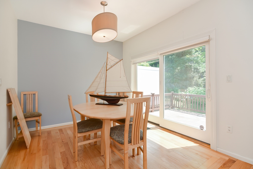 327 Bishops Forest Drive, Unit 327 Waltham, MA 02452 - Photo 13 of 38 a view of a dining room with furniture and wooden floor