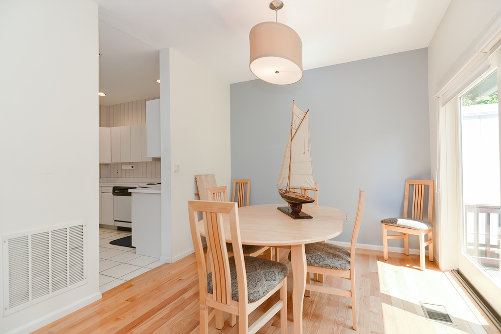 327 Bishops Forest Drive, Unit 327 Waltham, MA 02452 - Photo 14 of 38 a view of a dining room with furniture and wooden floor