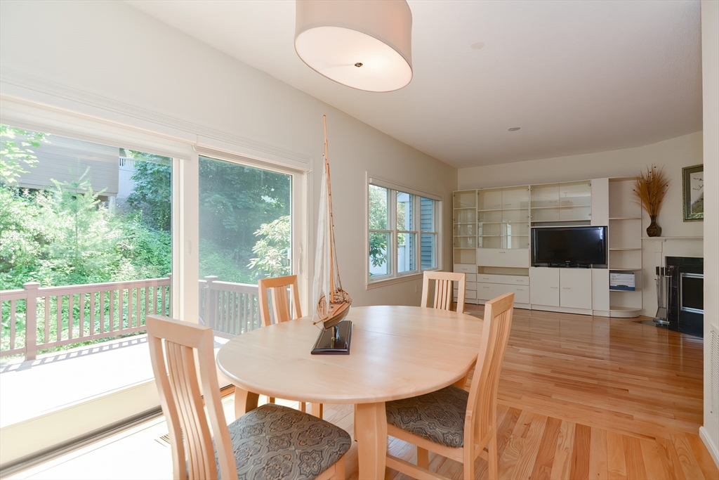 327 Bishops Forest Drive, Unit 327 Waltham, MA 02452 - Photo 15 of 38 a view of a dining room with furniture window and wooden floor