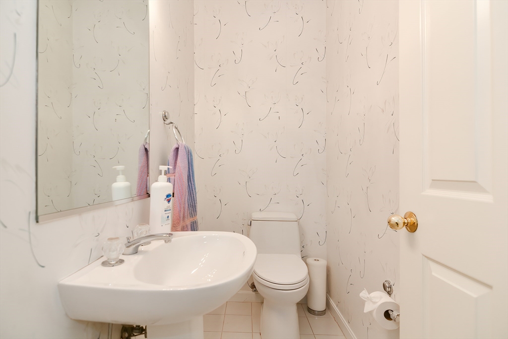 327 Bishops Forest Drive, Unit 327 Waltham, MA 02452 - Photo 19 of 38 a bathroom with a sink a toilet and shower curtain