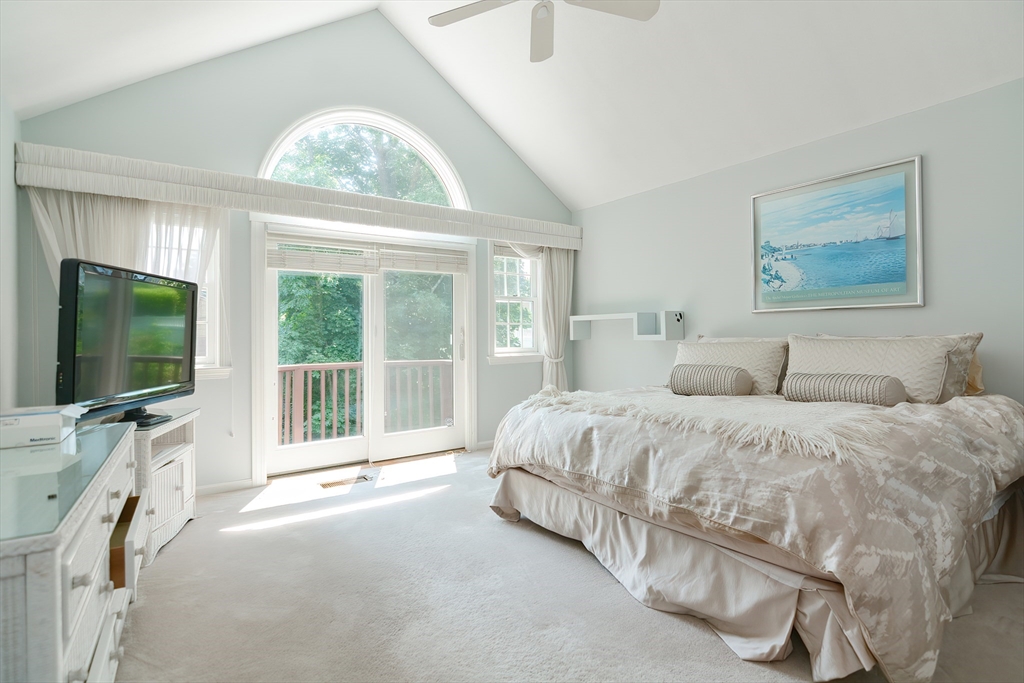 327 Bishops Forest Drive, Unit 327 Waltham, MA 02452 - Photo 20 of 38 a spacious bedroom with a bed and a flat screen tv