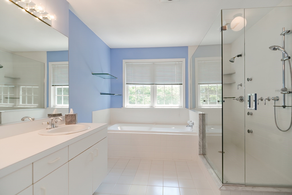 327 Bishops Forest Drive, Unit 327 Waltham, MA 02452 - Photo 22 of 38 a bathroom with a sink a toilet and shower