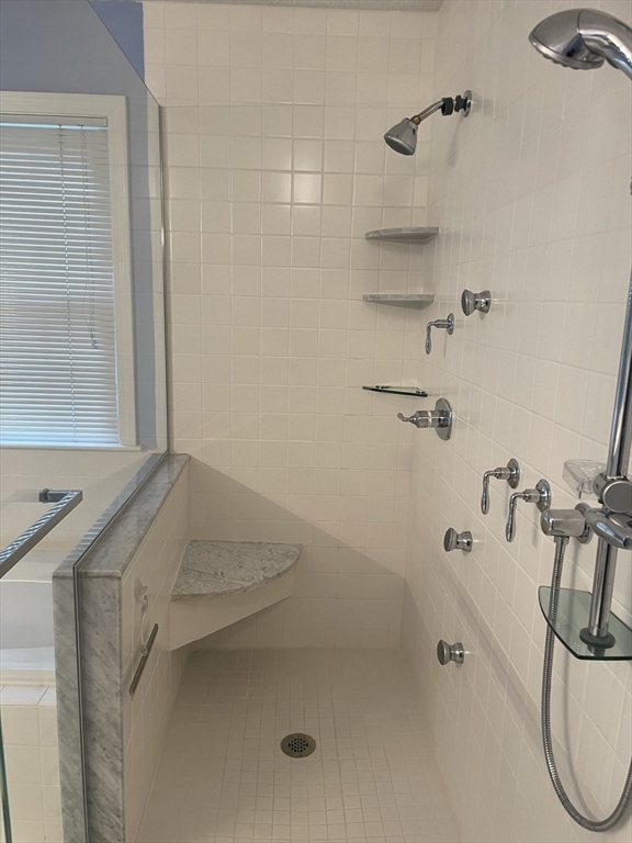 327 Bishops Forest Drive, Unit 327 Waltham, MA 02452 - Photo 24 of 38 a bathroom with a sink and a shower