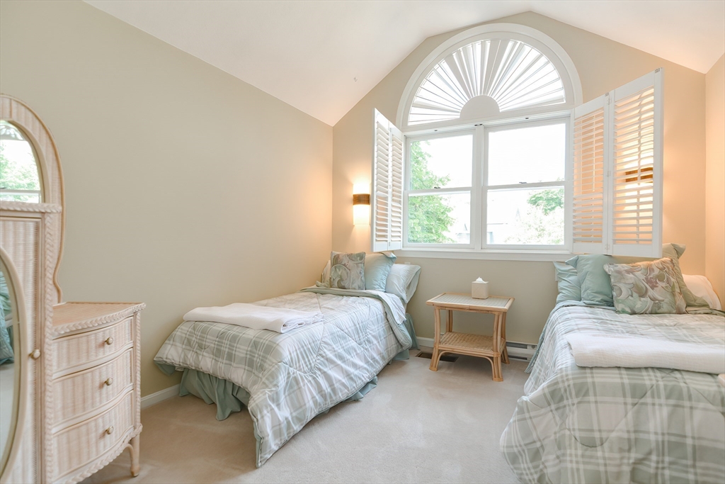 327 Bishops Forest Drive, Unit 327 Waltham, MA 02452 - Photo 26 of 38 a bedroom with a bed and a window