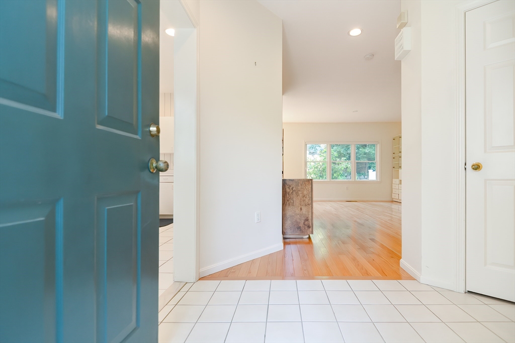 327 Bishops Forest Drive, Unit 327 Waltham, MA 02452 - Photo 3 of 38 a view of a hallway with wooden floor