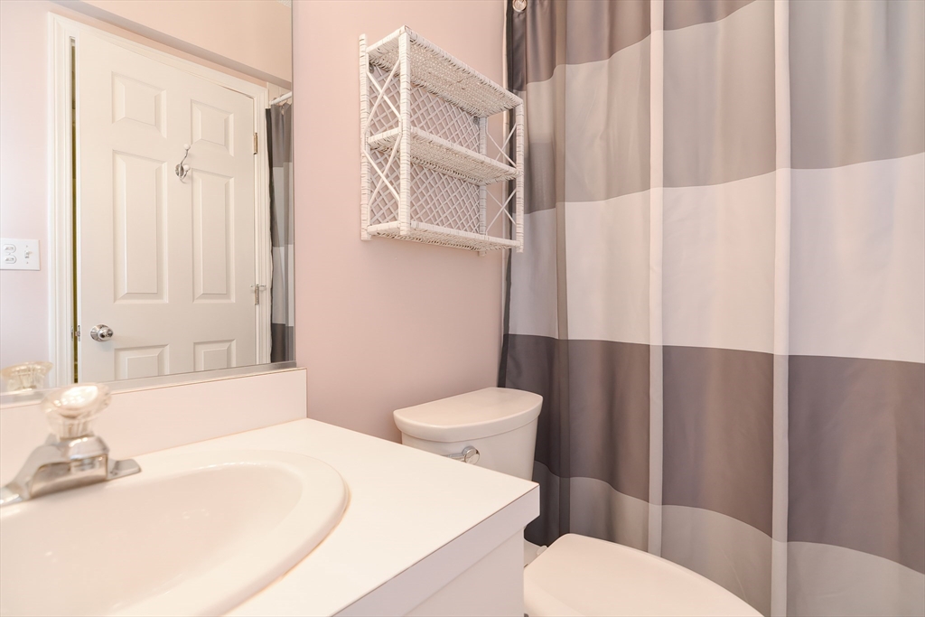 327 Bishops Forest Drive, Unit 327 Waltham, MA 02452 - Photo 34 of 38 a white toilet sitting next to a bathroom sink