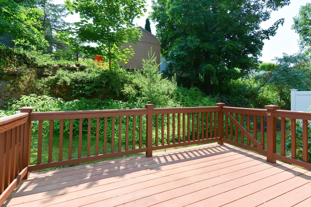327 Bishops Forest Drive, Unit 327 Waltham, MA 02452 - Photo 35 of 38 a view of balcony with wooden floor and fence