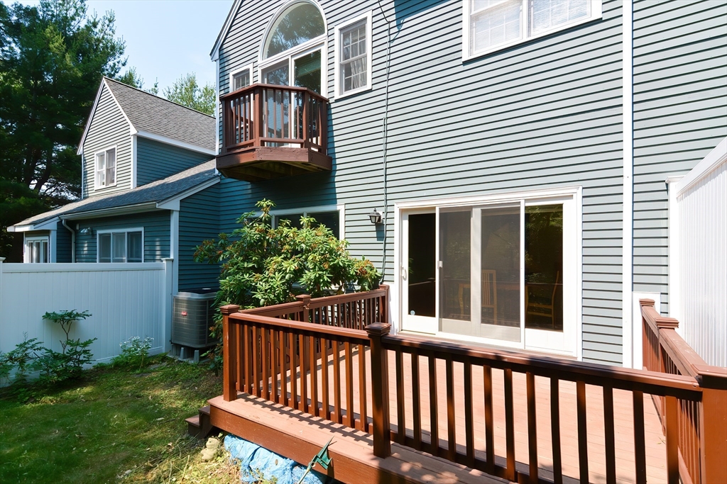 327 Bishops Forest Drive, Unit 327 Waltham, MA 02452 - Photo 37 of 38 a view of a house with a small yard and wooden fence