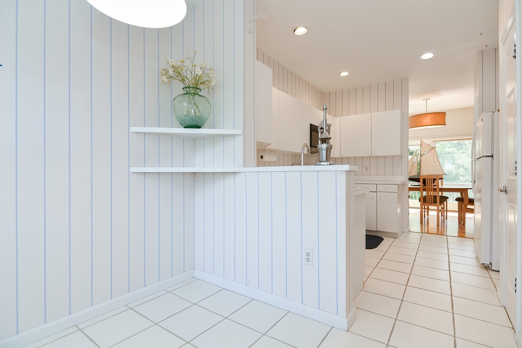 327 Bishops Forest Drive, Unit 327 Waltham, MA 02452 - Photo 7 of 38 a view of kitchen with furniture and floor to ceiling window
