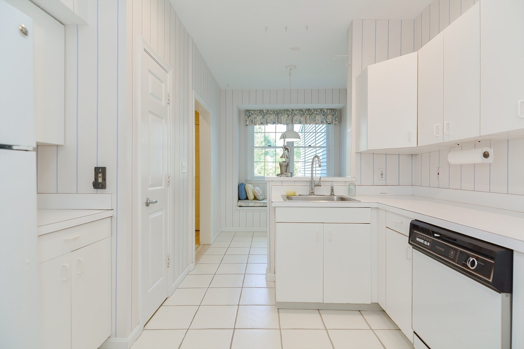 327 Bishops Forest Drive, Unit 327 Waltham, MA 02452 - Photo 8 of 38 a kitchen with stainless steel appliances a sink stove and cabinets