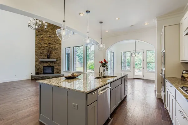 a kitchen with sink cabinets and wooden floor