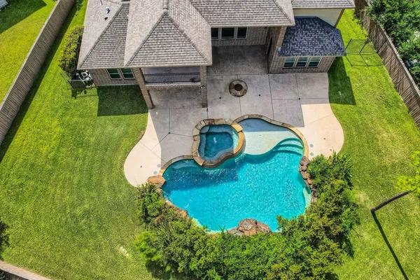an aerial view of a house with outdoor space