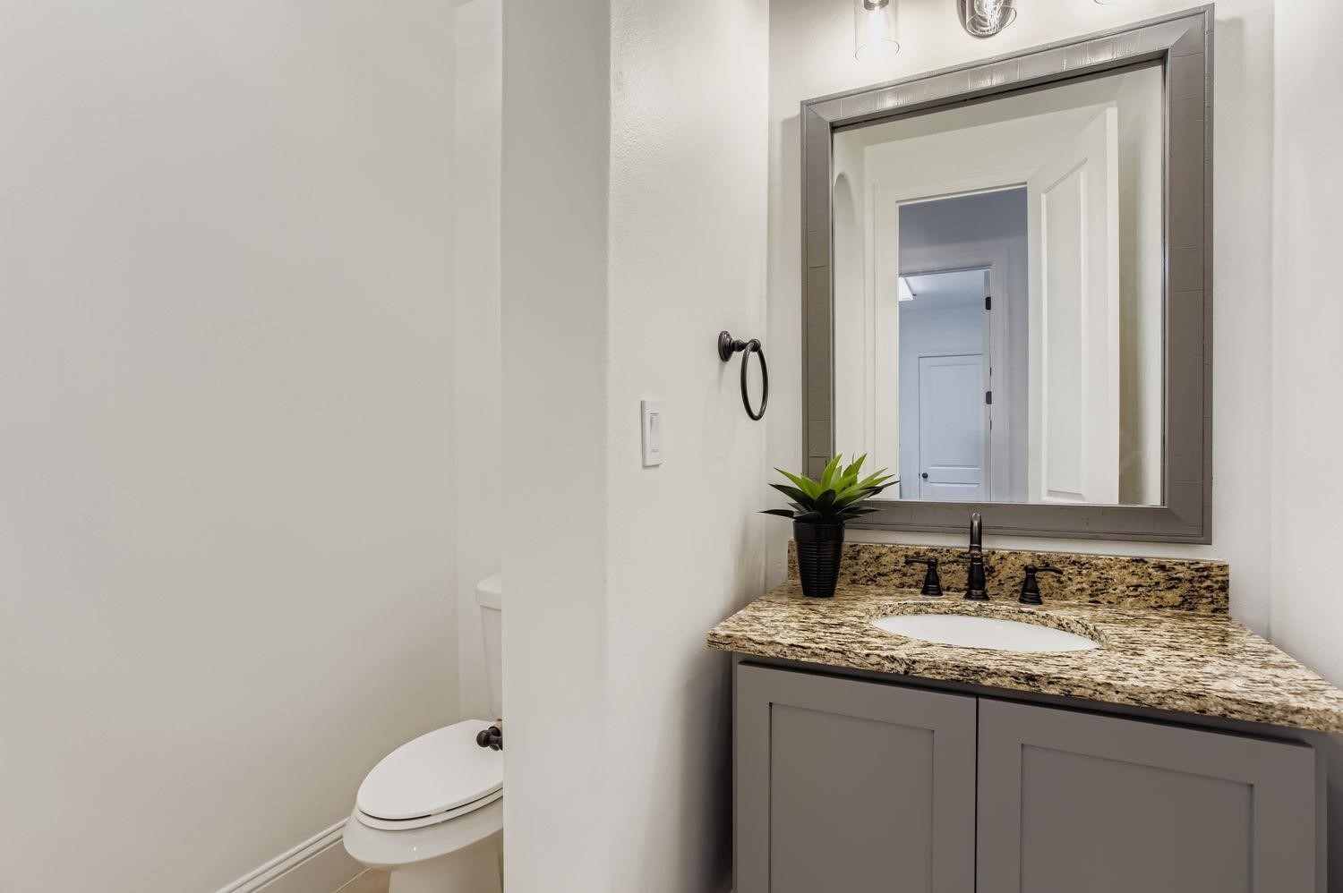 6 Freestone Stream Place The Woodlands, TX 77389 - Photo 24 of 50 a bathroom with a granite countertop sink toilet and mirror