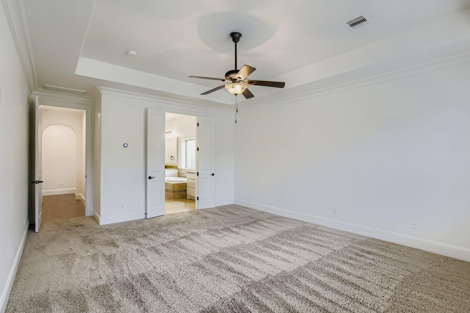 6 Freestone Stream Place The Woodlands, TX 77389 - Photo 25 of 50 a bedroom with a bed and a chandelier