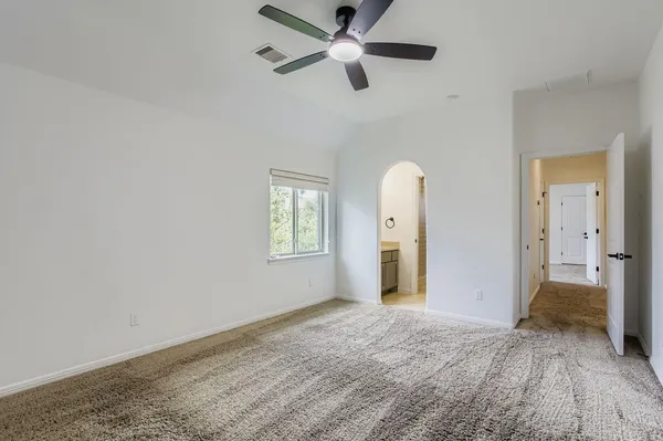 a bedroom with a large bed and a chandelier