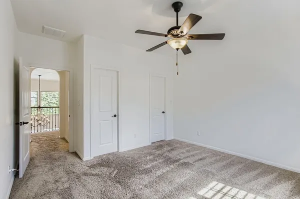 a bathroom with a granite countertop toilet a sink and mirror