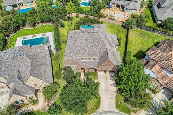 an aerial view of a house with a garden and yard