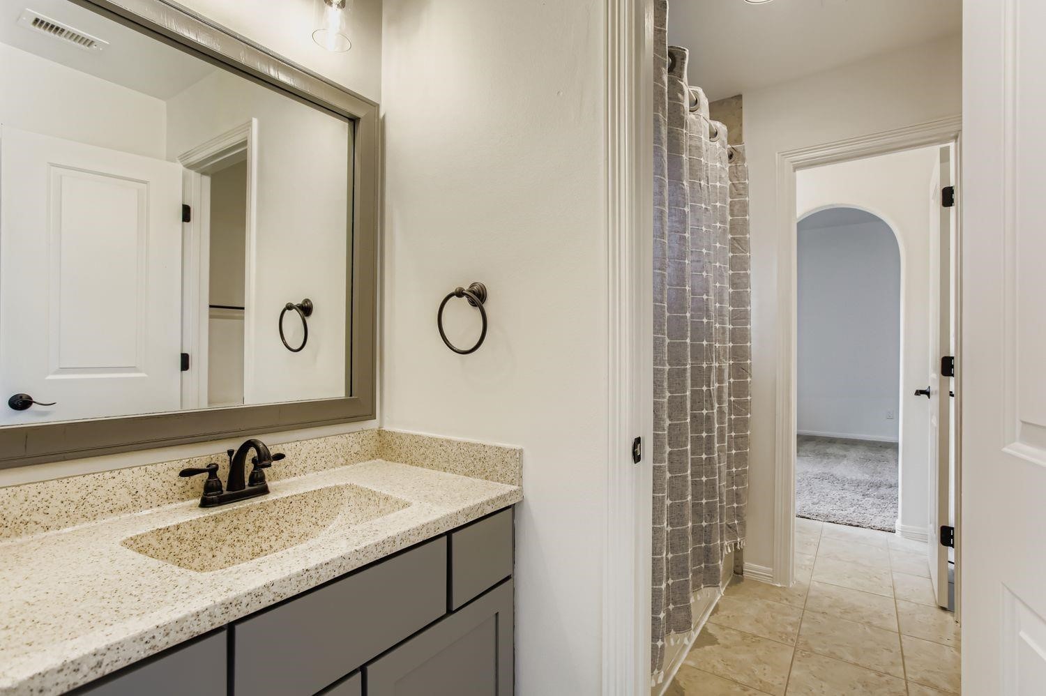 6 Freestone Stream Place The Woodlands, TX 77389 - Photo 41 of 50 a bathroom with a granite countertop sink a mirror and a shower