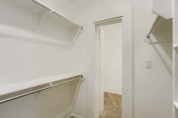 a large white kitchen with granite countertop a sink cabinets stainless steel appliances and a window