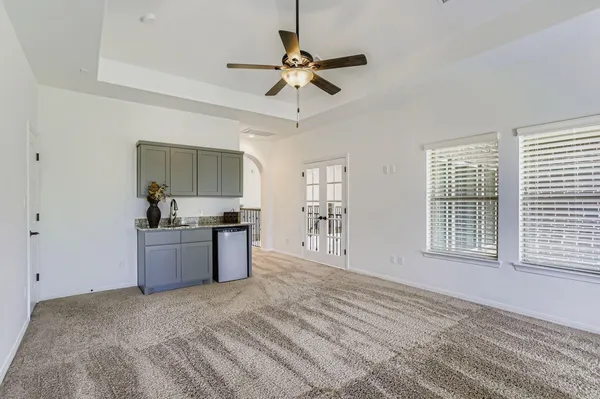 a room with furniture pool table and windows