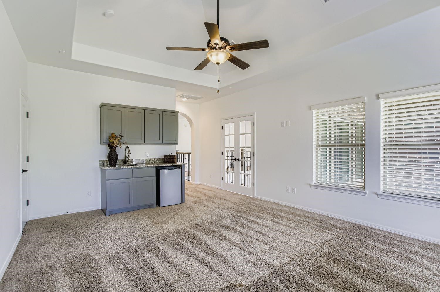 6 Freestone Stream Place The Woodlands, TX 77389 - Photo 44 of 50 a large white kitchen with granite countertop a sink cabinets stainless steel appliances and a window