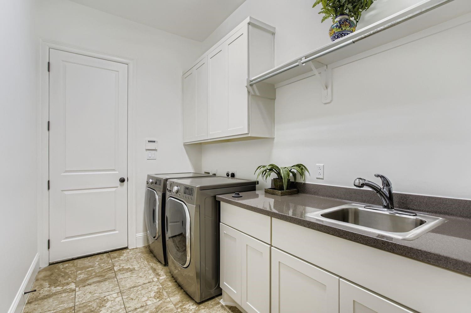 6 Freestone Stream Place The Woodlands, TX 77389 - Photo 48 of 50 a kitchen with stainless steel appliances granite countertop a sink stove and cabinets