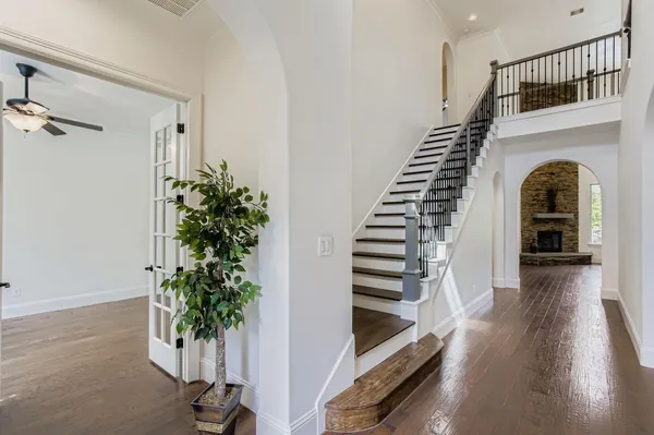 a view of entryway and hall with wooden floor