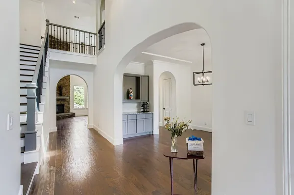 a view of entryway and hall with wooden floor