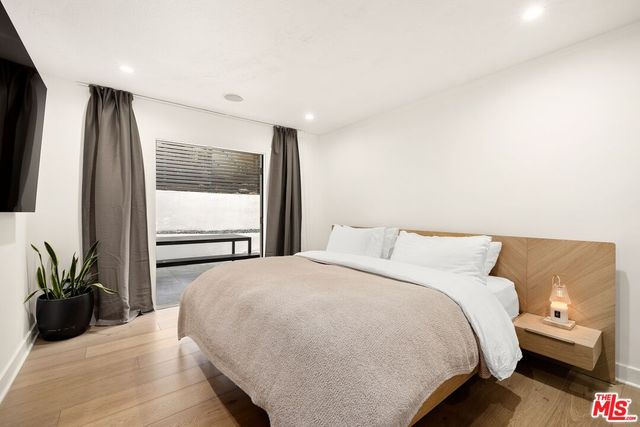 a bedroom with a bed and a large window