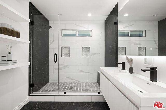 a bathroom with a tub sink and shower