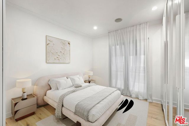 a bedroom with a bed and a large mirror