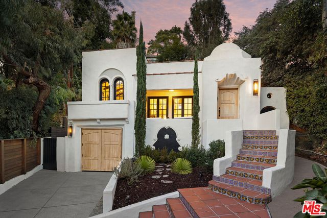 a front view of a house with garden