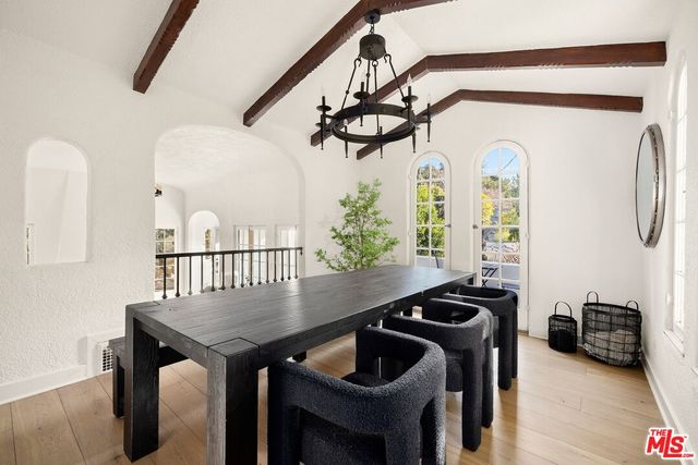 a view of a dining room with furniture and a chandelier