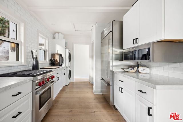 a kitchen with stainless steel appliances granite countertop a sink and a stove
