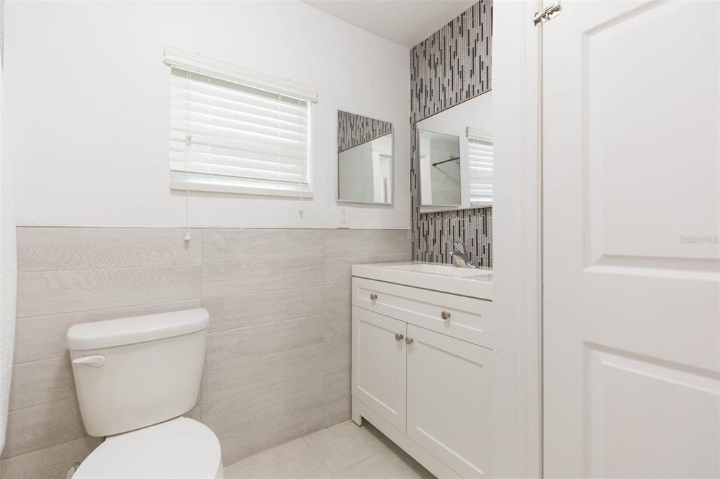 118 West Sligh Avenue Tampa, FL 33604 - Photo 14 of 20 a bathroom with a toilet sink and mirror