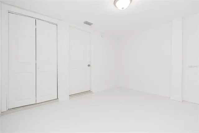 a view of a backyard with large trees and plants