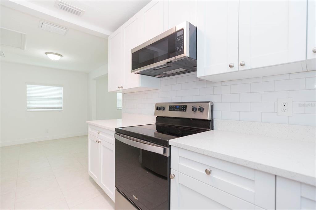 118 West Sligh Avenue Tampa, FL 33604 - Photo 5 of 20 a kitchen with a stove and a microwave