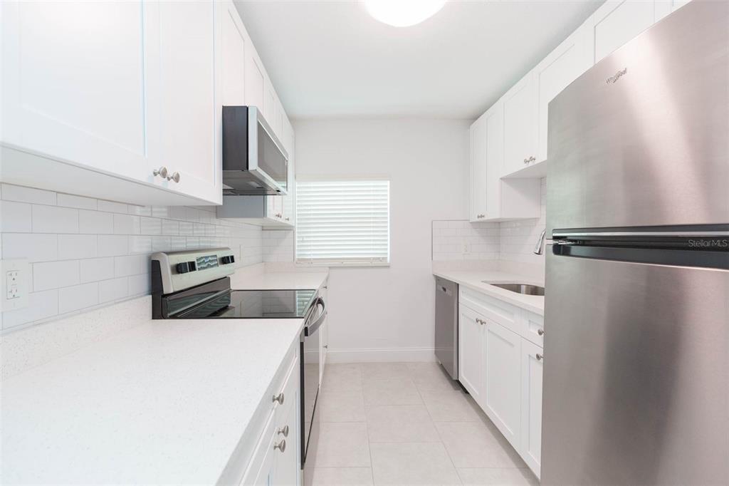 118 West Sligh Avenue Tampa, FL 33604 - Photo 7 of 20 a kitchen with granite countertop a sink stove and refrigerator